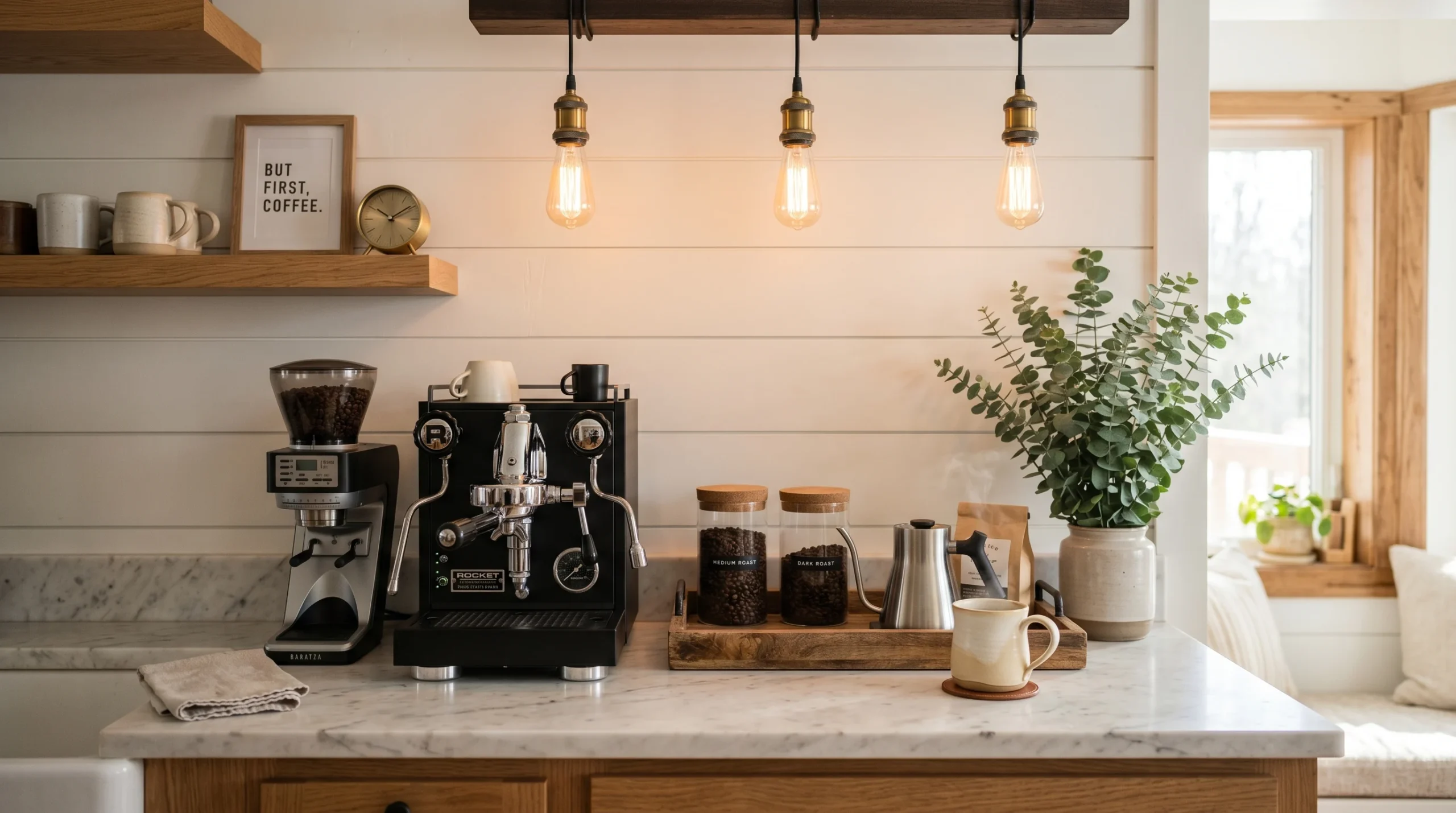 Styled home coffee bar ideas with marble counter, black espresso machine, wooden tray, and warm Edison lighting against white shiplap wall.
